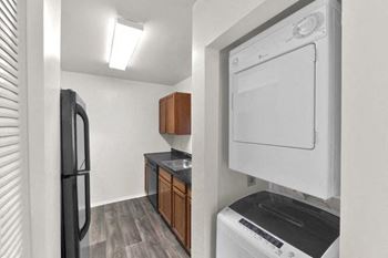 a small kitchen with a stove and a refrigerator